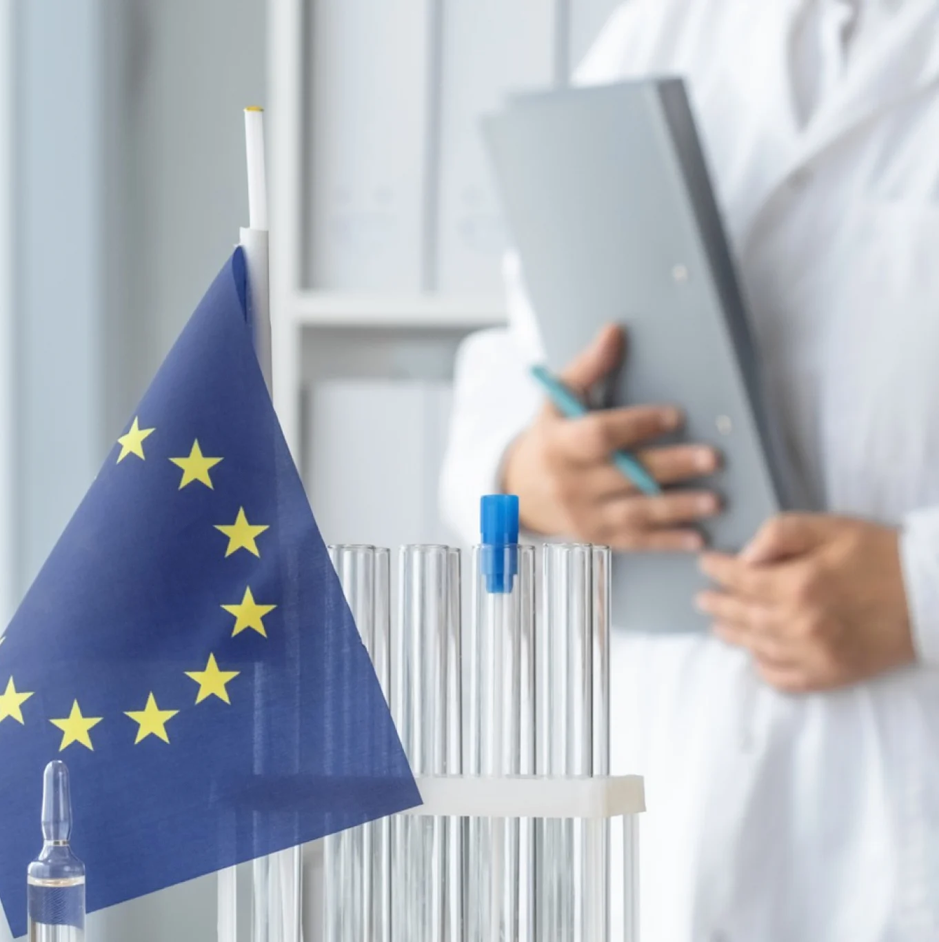 The European Union flag beside a rack of test tubes in the clinic laboratory